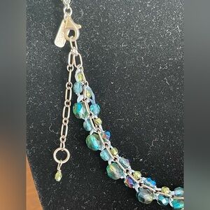 Holly Yashi faceted beads macraméd on a silver chain. 925SS. 16”+2” extension.